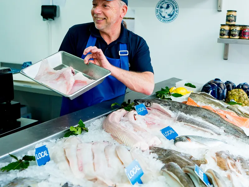 Steve with a tray of fillets over the counter