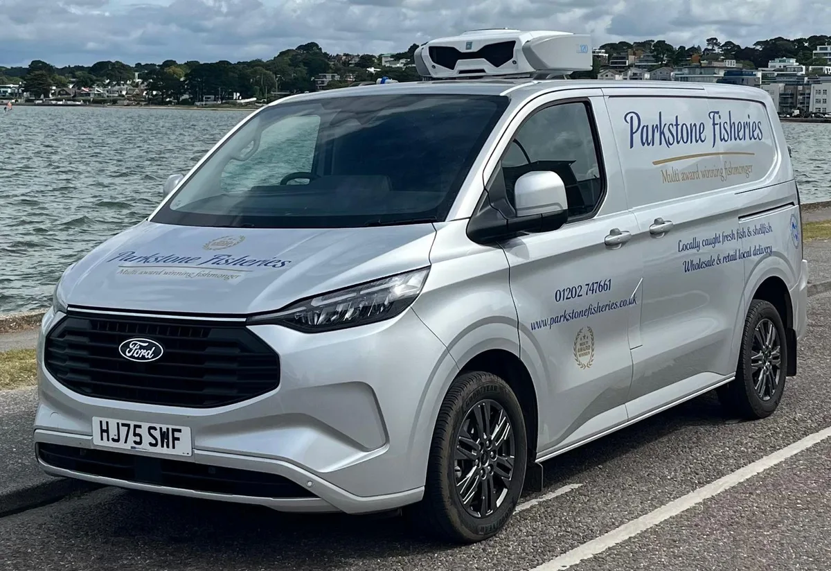 The Parkstone Fisheries refrigerated delivery van, roof-mounted chiller unit visible, parked beside Poole Harbour