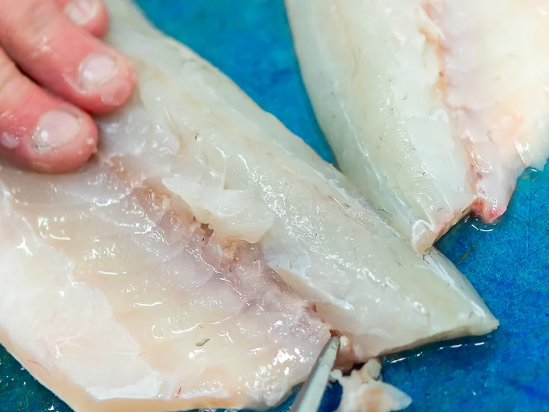 Expert fish preparation at Parkstone Fisheries: filleting to order