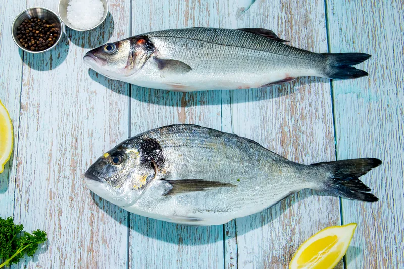 Whole farmed bass and bream with lemon and herbs at Parkstone Fisheries, Poole