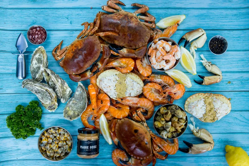 A seafood spread of whole cooked crabs, dressed crabs, shell-on prawns, oysters, crab claws and Marie Rose sauce