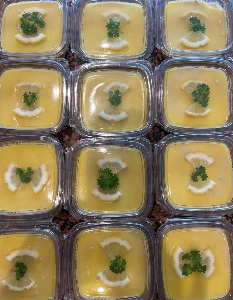 Tubs of homemade smoked mackerel pate, each topped with lemon and parsley