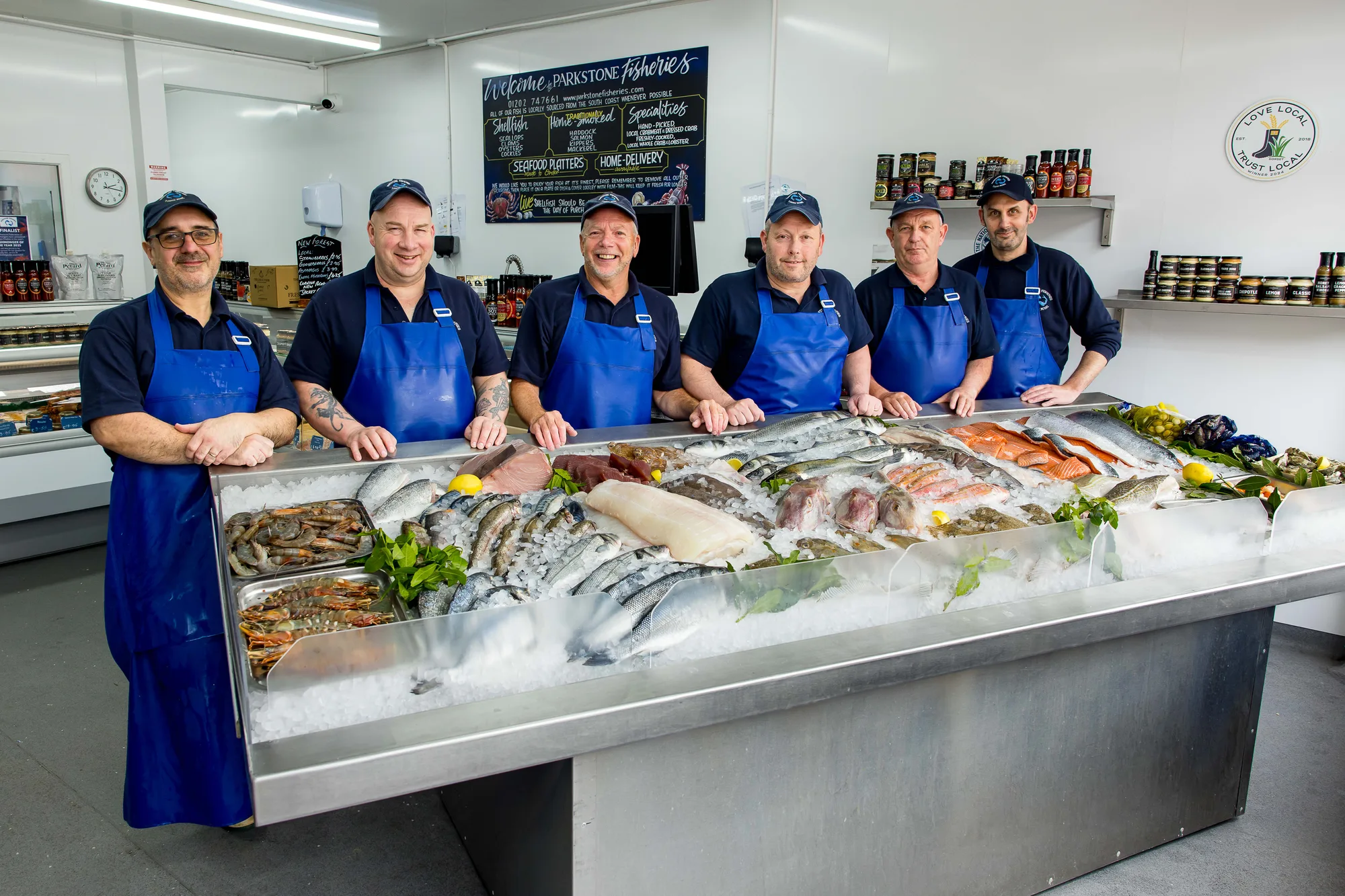 The Parkstone Fisheries team behind the counter in Poole, with the day's catch laid out on ice