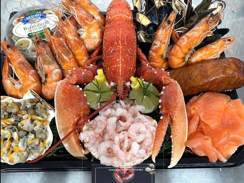 Seafood platter with a whole cooked lobster centrepiece, king prawns, mussels, cockles and smoked salmon, built at Parkstone Fisheries, Poole